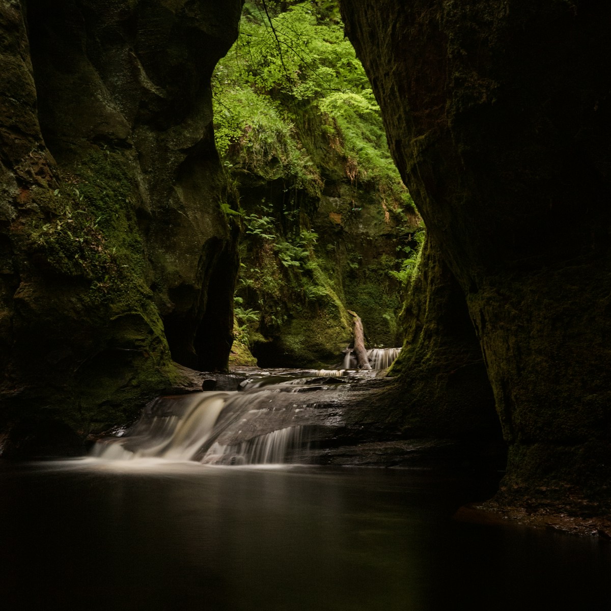 a small waterfall in the middle of a cave